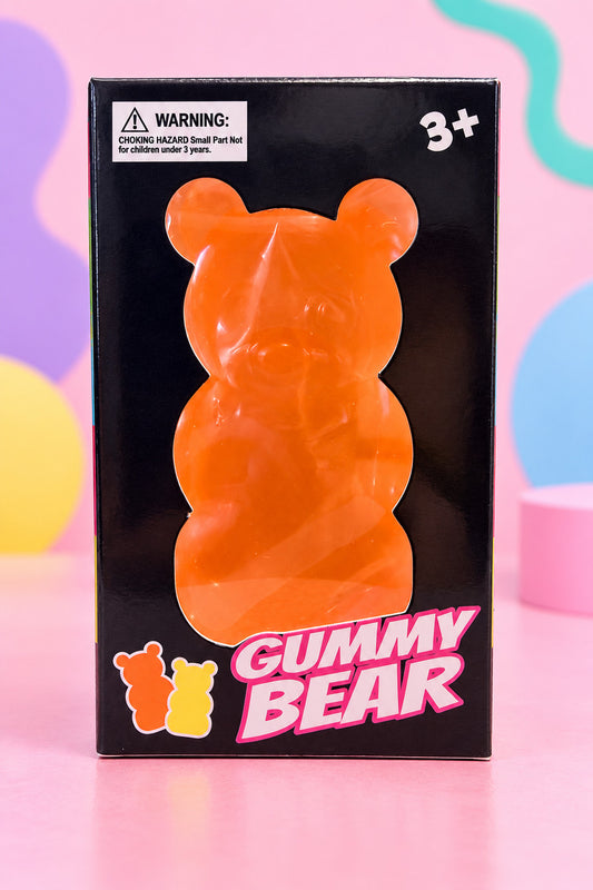 Orange Gummy Bear squishy toy in its black window box, ages 3 and up