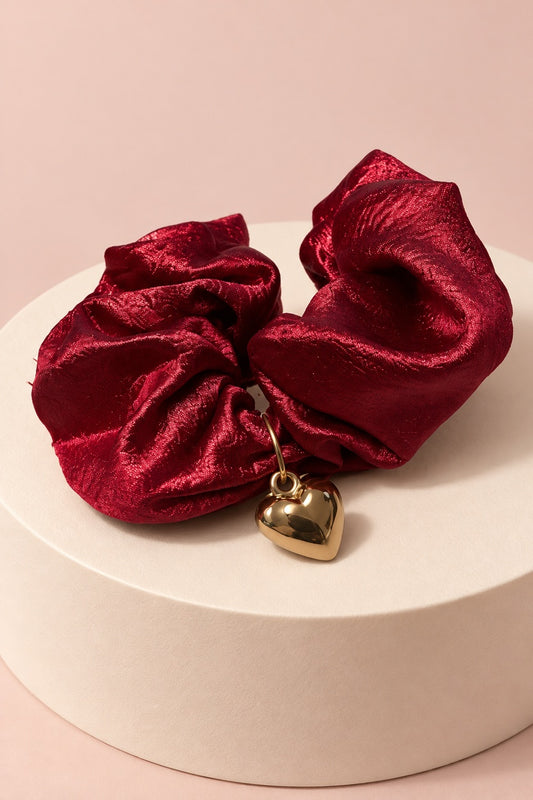 Burgundy Melody heart-charm scrunchie with glossy gathered fabric and gold-tone heart