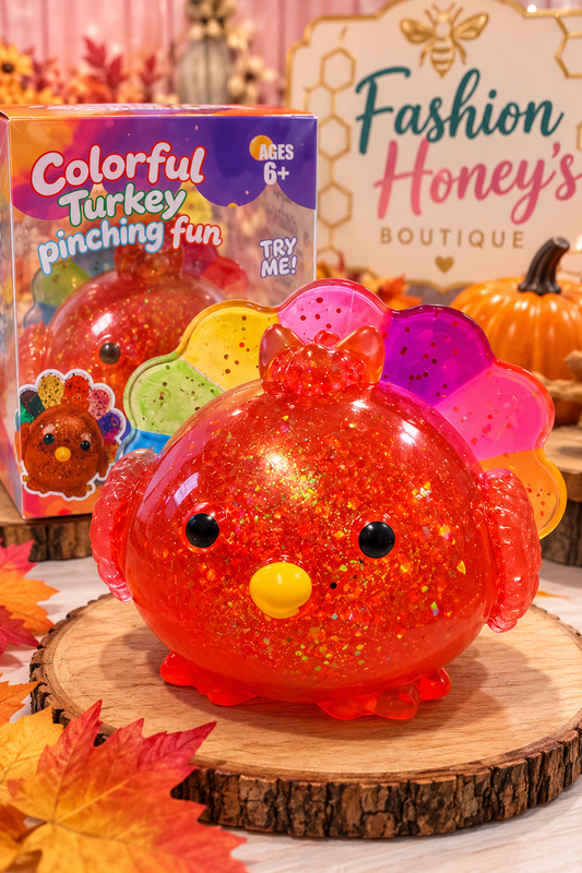 Colorful Turkey Pinch Squishy orange-red glitter body and rainbow tail on autumn boutique display