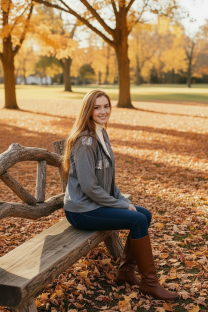Gray ribbed sequin hoodie on a model seated on a park bench