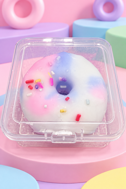 Pink, blue and white sprinkle-topped Crispy Balls Donut in a clear container