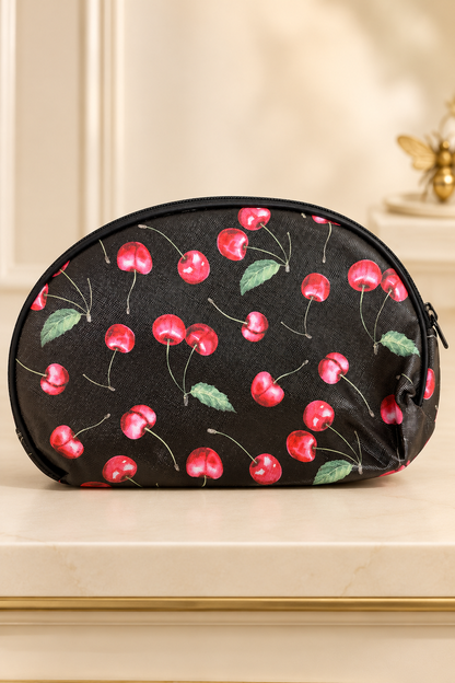 black background, realistic watercolor-style red cherries and green leaves, fine stems; black zipper and piping cherry-print makeup bag. One selected bag per purchase.