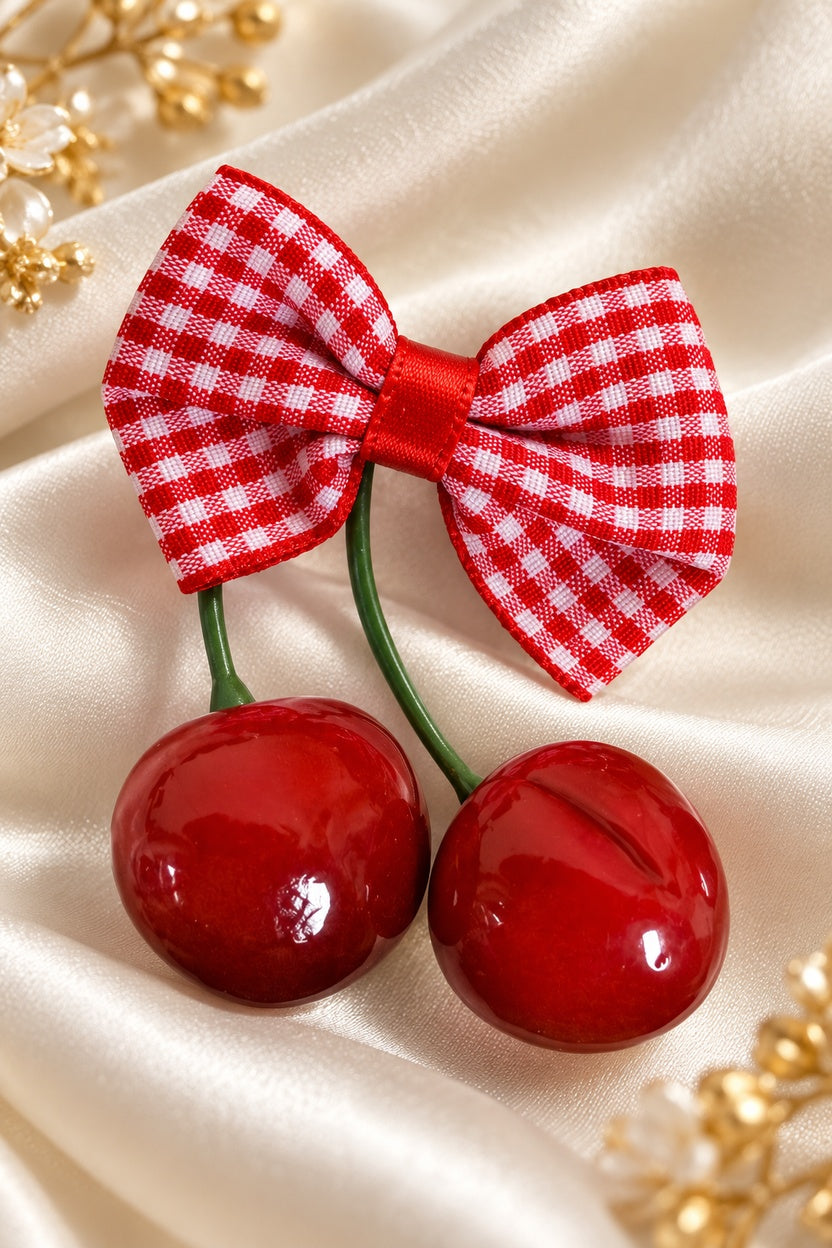 Close-up of one Red Gingham cherry bow barrette; each purchased set includes two matching clips