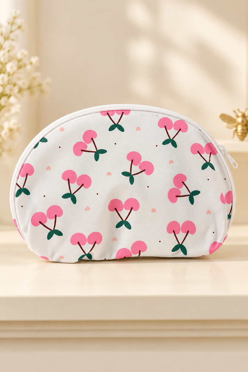 white background, flat pink paired cherries, dark green leaves, tiny pink hearts/dots; white zipper and piping cherry-print makeup bag. One selected bag per purchase.