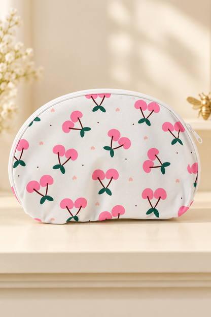 white background, flat pink paired cherries, dark green leaves, tiny pink hearts/dots; white zipper and piping cherry-print makeup bag. One selected bag per purchase.