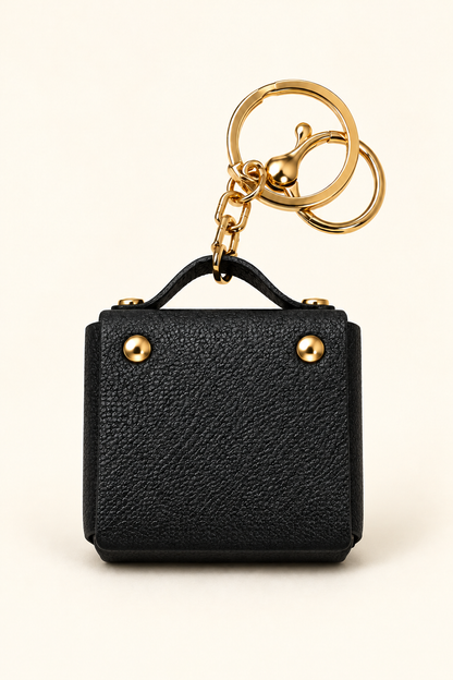 Black mini coin purse keychain with gold-tone hardware