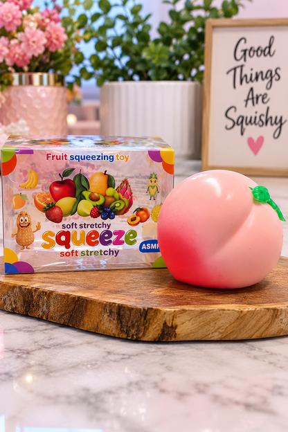 Pink peach fruit squishy displayed beside original retail package