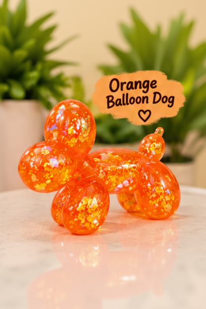 Orange glitter-filled Cube Squeeze balloon dog squishy toy