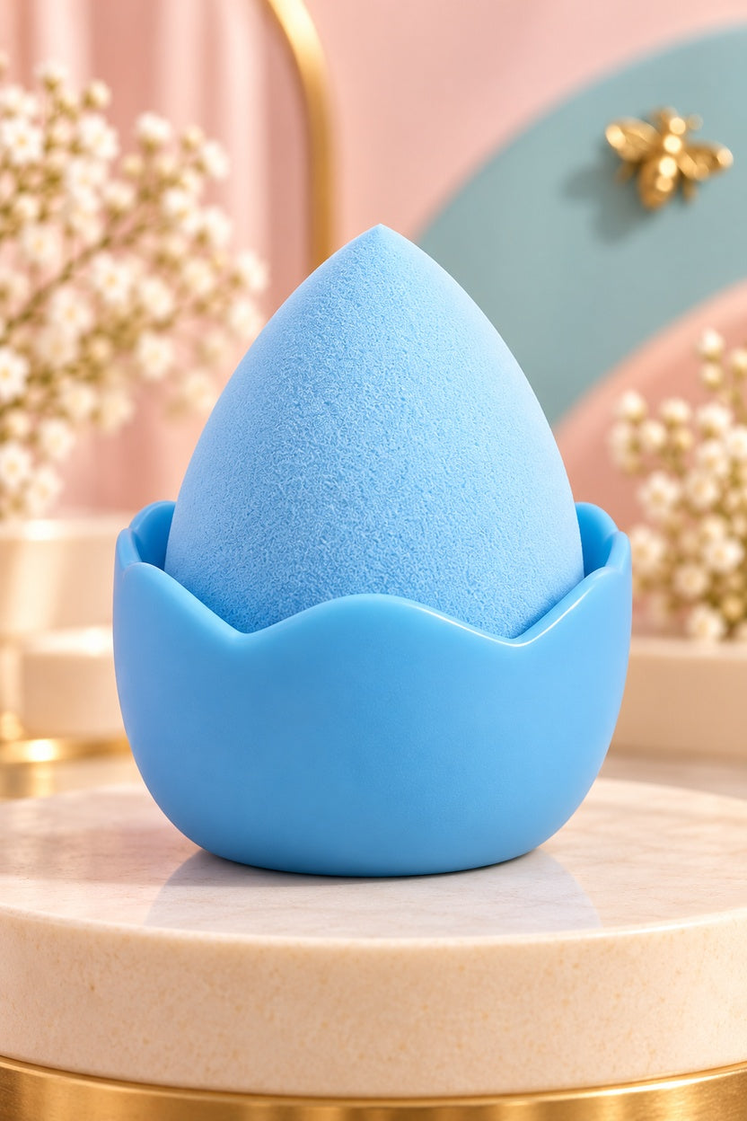 Blue makeup sponge in its plain coordinating stand, shown unpackaged; one boxed set per purchase