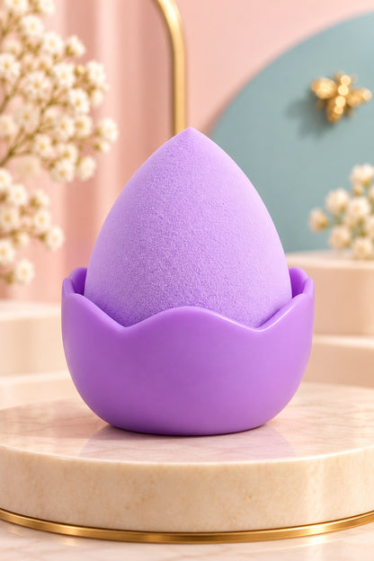 Lavender makeup sponge in its plain coordinating stand, shown unpackaged; one boxed set per purchase