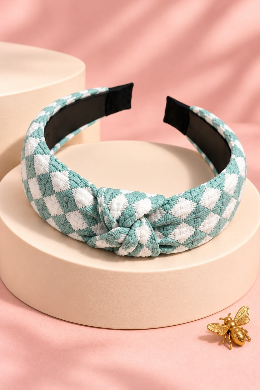 Mint Green checkered top-knot headband with white checks on a boutique display