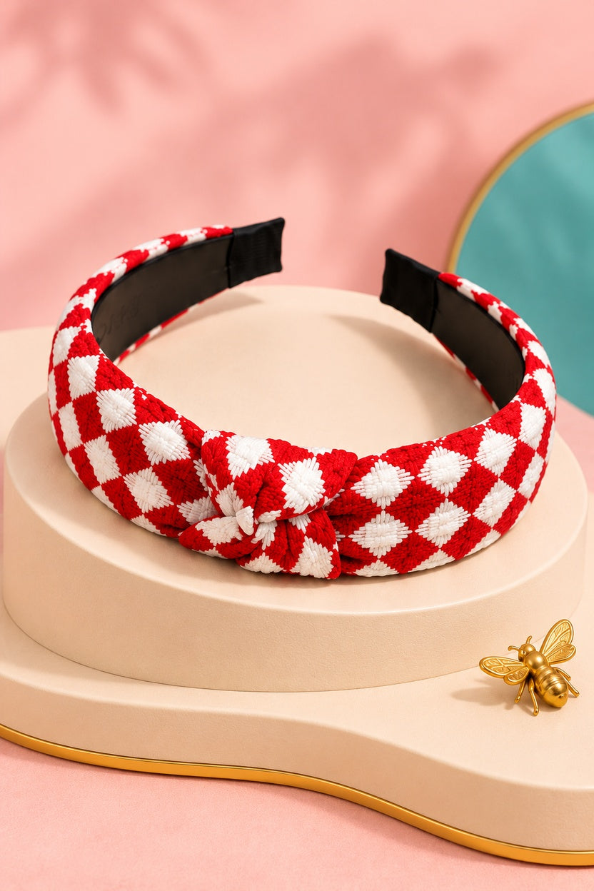 Red checkered top-knot headband with white checks on a boutique display