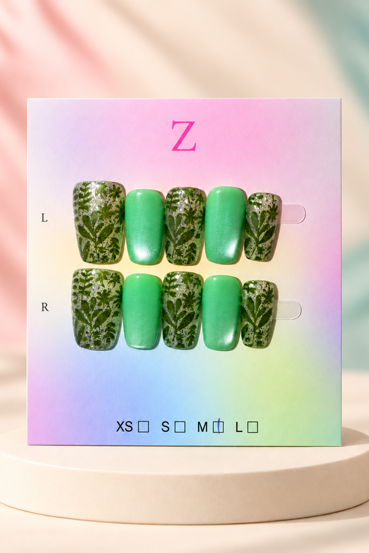 Original manufacturer card and green botanical shimmer nail set displayed without wrapper on cream plinth