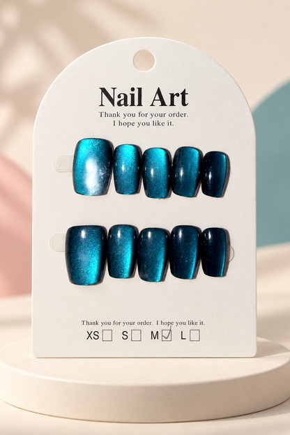 Teal Cat-Eye Shimmer Press-On / Glue-On Nails – Squoval Size M; original manufacturer card displayed without outer wrapper on a cream studio plinth