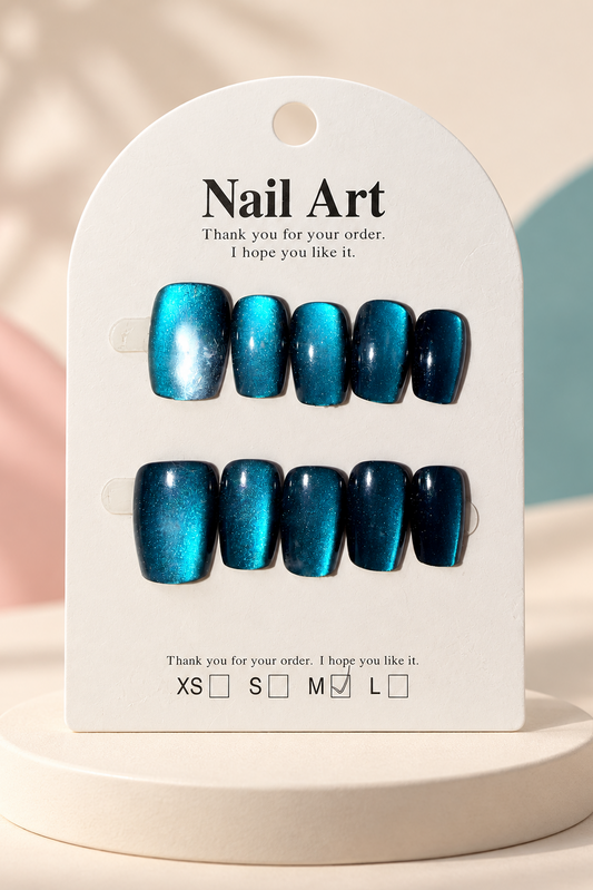 Teal Cat-Eye Shimmer Press-On / Glue-On Nails – Squoval Size M; original manufacturer card displayed without outer wrapper on a cream studio plinth
