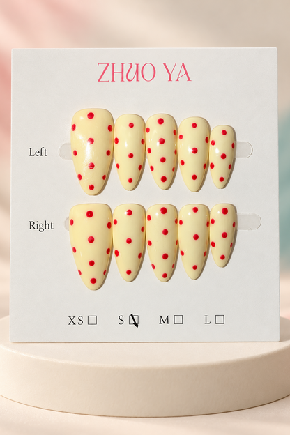 Pale Yellow Red Polka Dot Press-On / Glue-On Nails – Almond Size S; original manufacturer card displayed without outer wrapper on a cream studio plinth