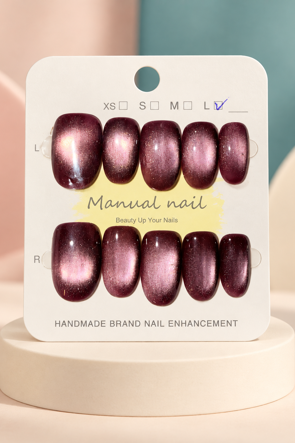 Deep Plum Cat-Eye Press-On / Glue-On Nails – Squoval Size L; original manufacturer card displayed without outer wrapper on a cream studio plinth