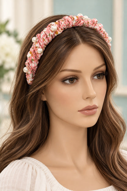 Pink floral ruched headband with pearl-style accents worn on a long-haired mannequin