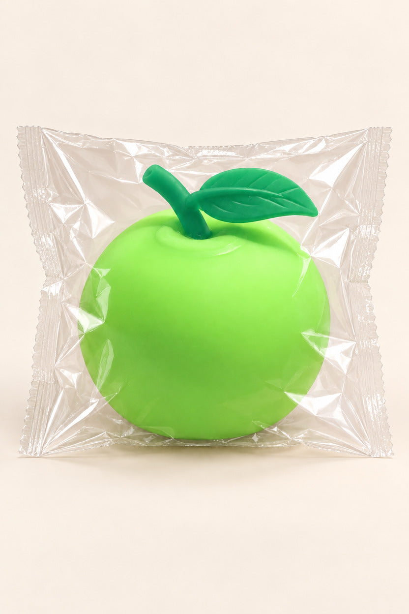 Lime green apple squishy packaged in a clear plastic wrapper