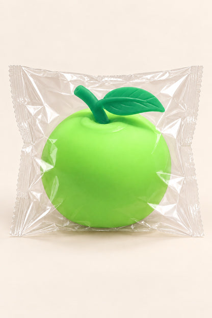 Lime green apple squishy packaged in a clear plastic wrapper