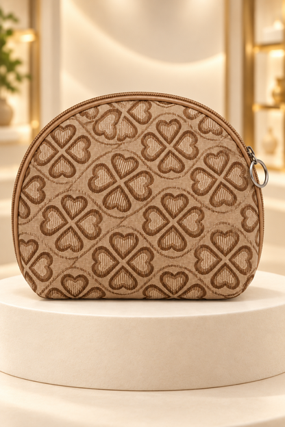 Gold heart-pattern makeup bag on a cream boutique display riser, shown unpackaged