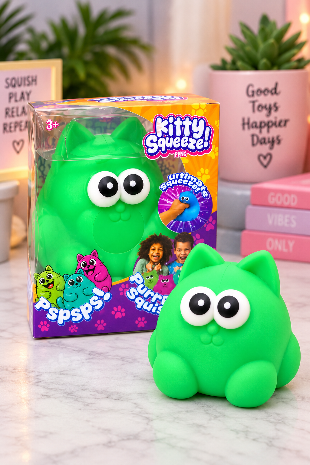Green Kitty Squeeze sensory toy with packaging on boutique-style background