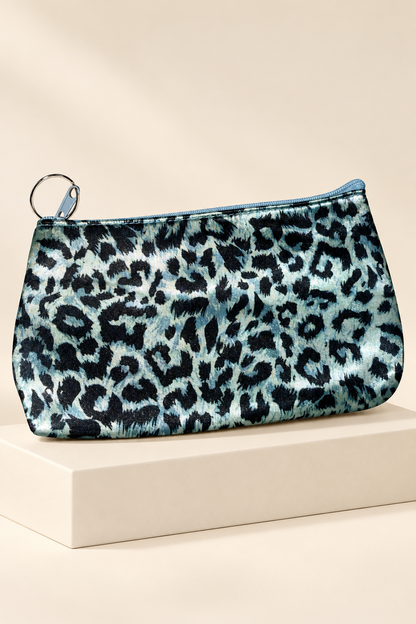 Light Blue/Black leopard-print makeup bag shown unpackaged on a cream boutique display riser
