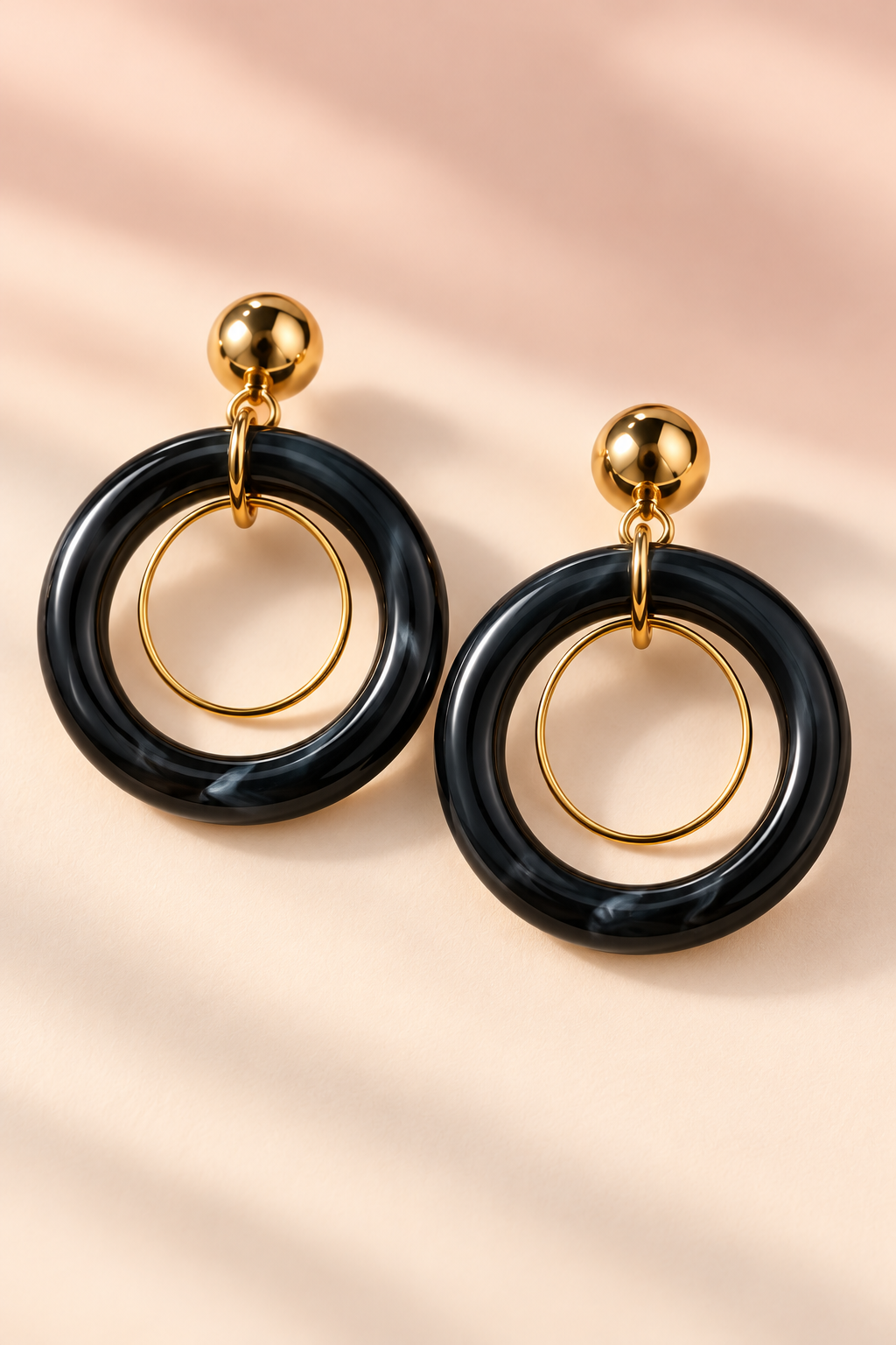 MINT Black double hoop earring pair with thin gold-tone inner loops and round gold-tone studs