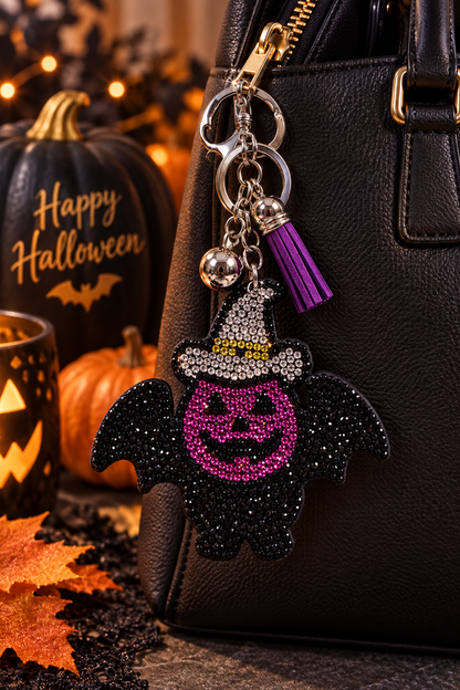 Purple pumpkin Halloween rhinestone keychain with silver hat and purple tassel on handbag