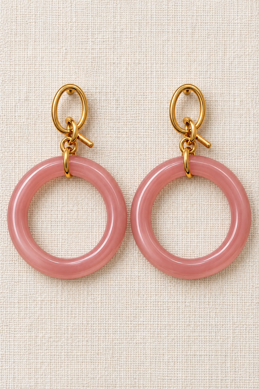 Close-up of round mauve pink MINT plastic hoops with gold-tone oval fronts and interlocking metal links