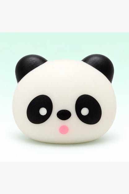 Three-inch black and white panda head squishy on a mint background