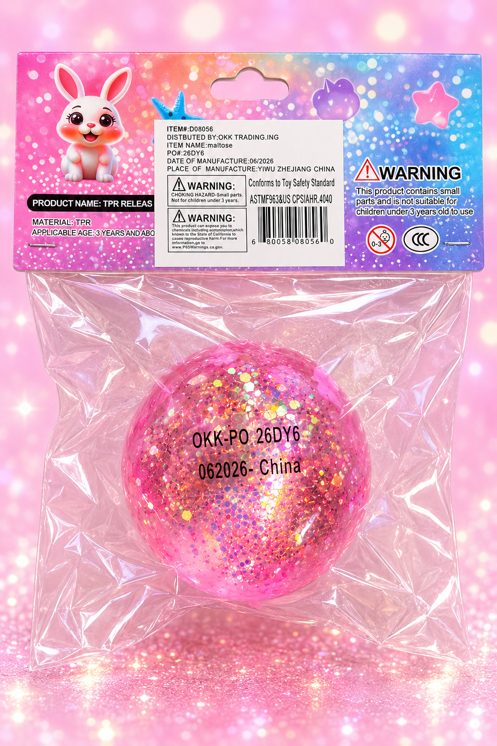Pink glitter ball squishy cleaned back packaging with item D08056 barcode and safety warnings