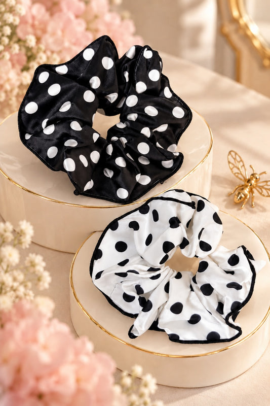 Black scrunchie with white polka dots and white scrunchie with black polka dots on a boutique display; one selected scrunchie sold
