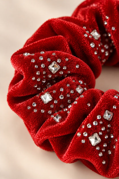 Close-up of Red scrunchie plush texture and round and square rhinestone trim