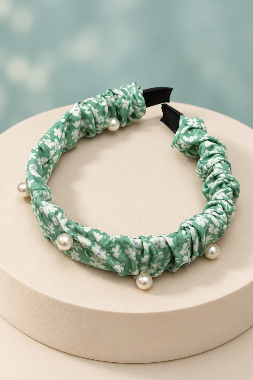 Mint Green ruched floral headband with pearl-style beads on a boutique display