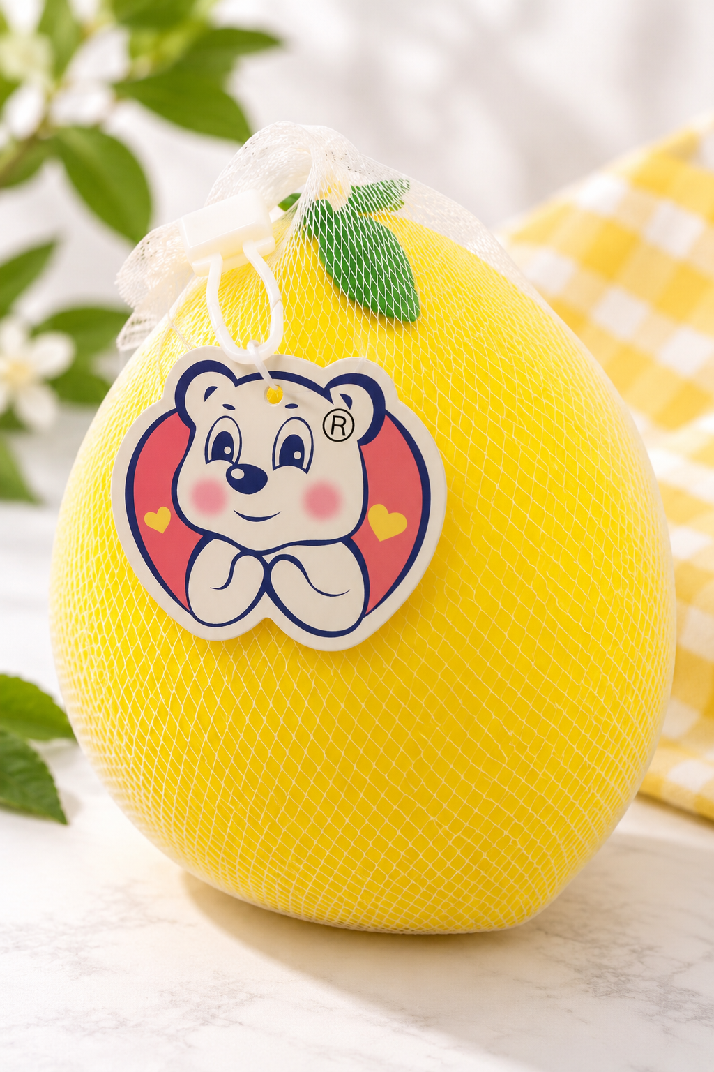 Jumbo lemon squishy in white mesh package with hanging tag