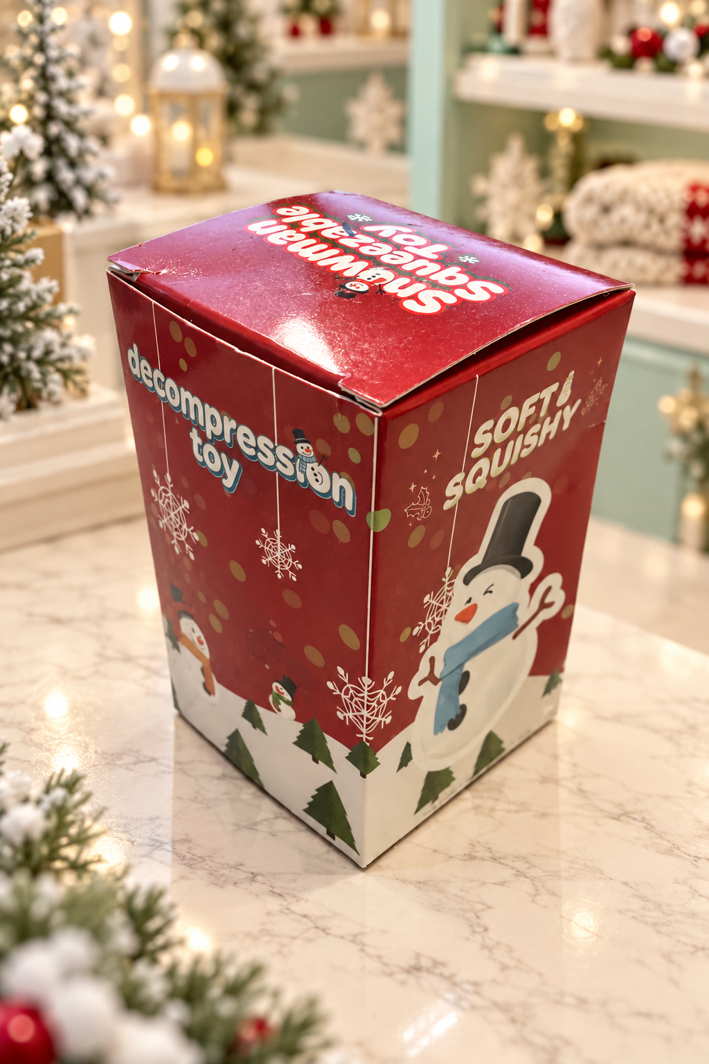 Angled view of the snowman squeezable toy retail packaging.