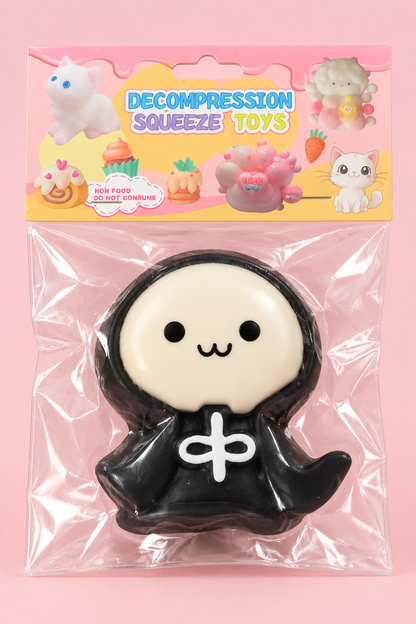 Illustrative front view of black and cream hooded character squishy in pastel package