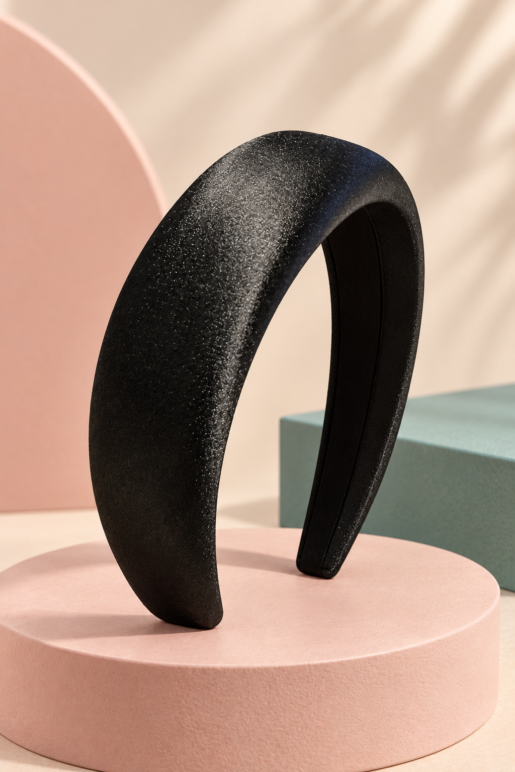 Black textured padded headband on a boutique display
