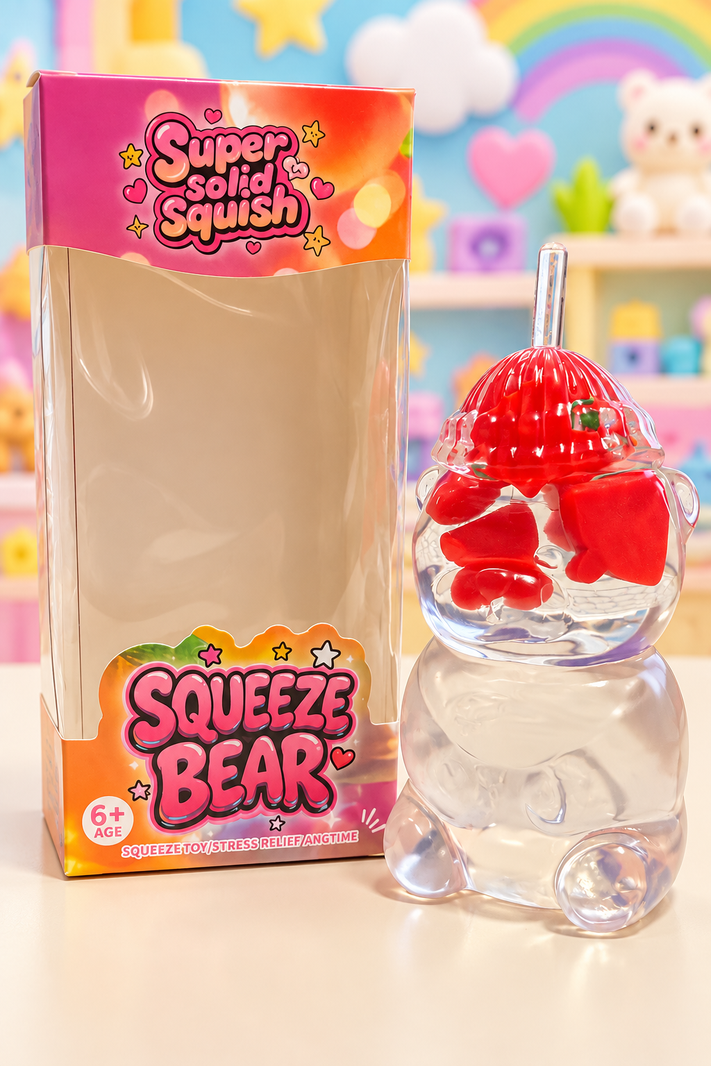Clear watermelon Squeeze Bear squishy beside its original retail box on a pastel toy display